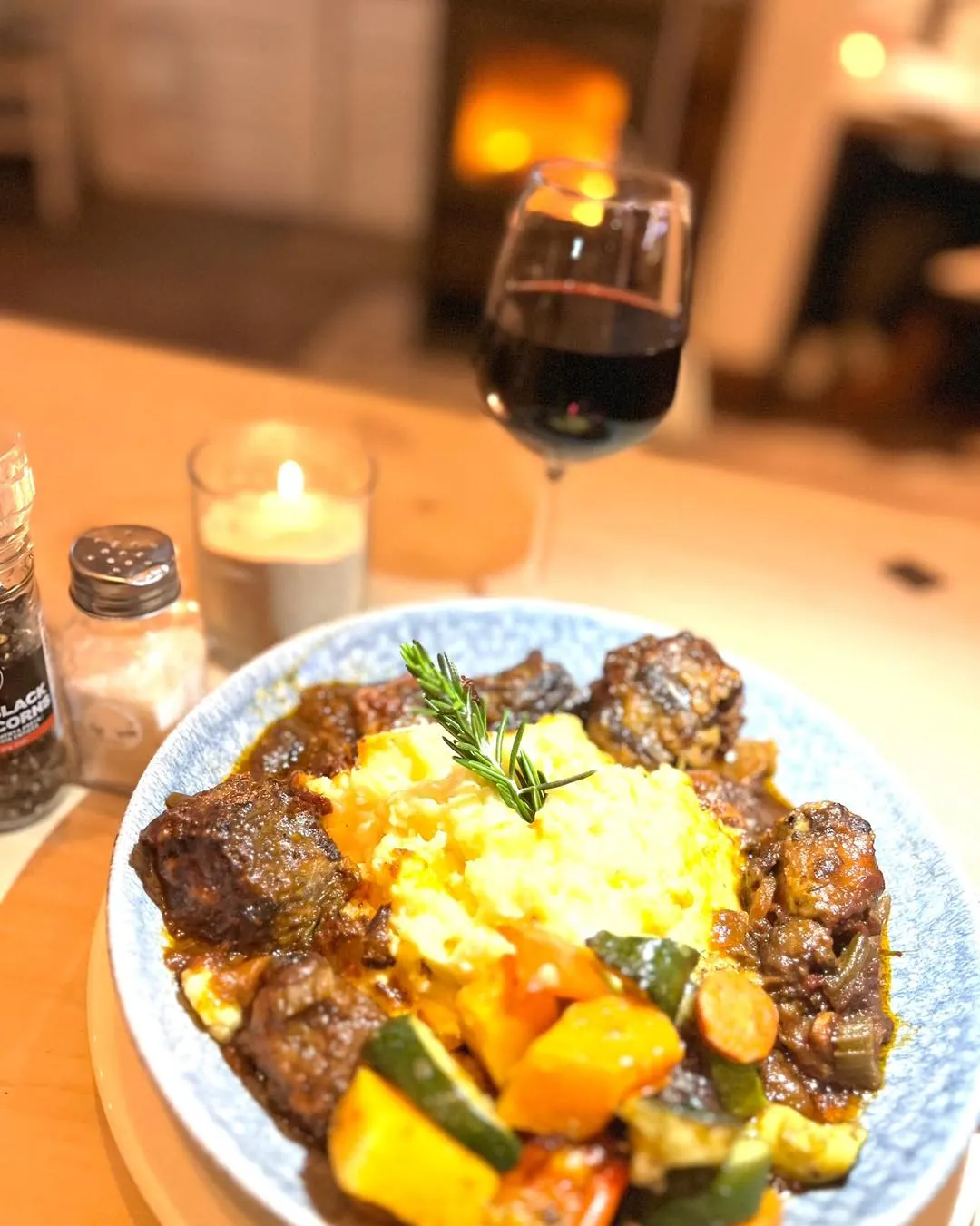 A slow-cooked dinner by candlelight with a glass of red wine