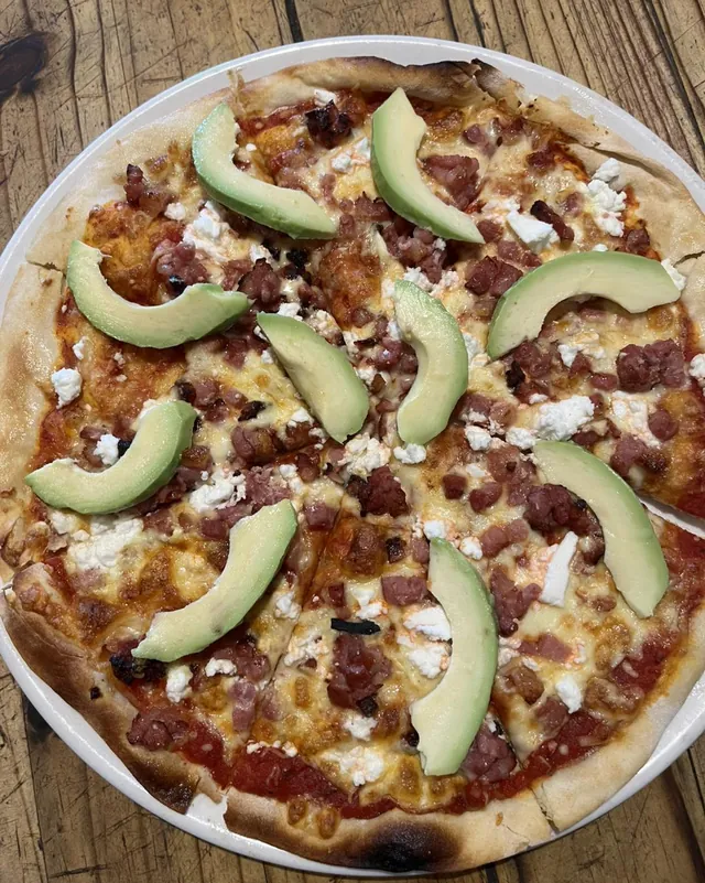 A wood-fired Hollywood pizza with bacon, feta and avocado